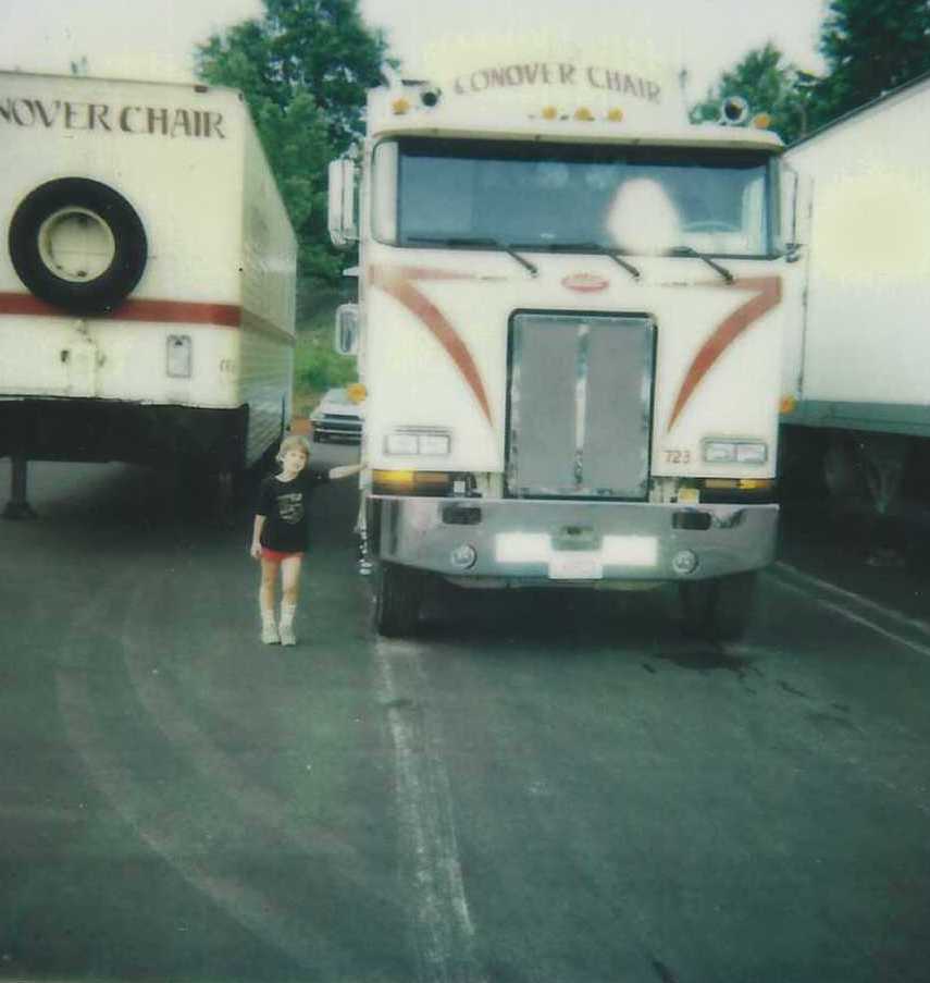 Alex Hendricks as a child beside a Conover Chair truck